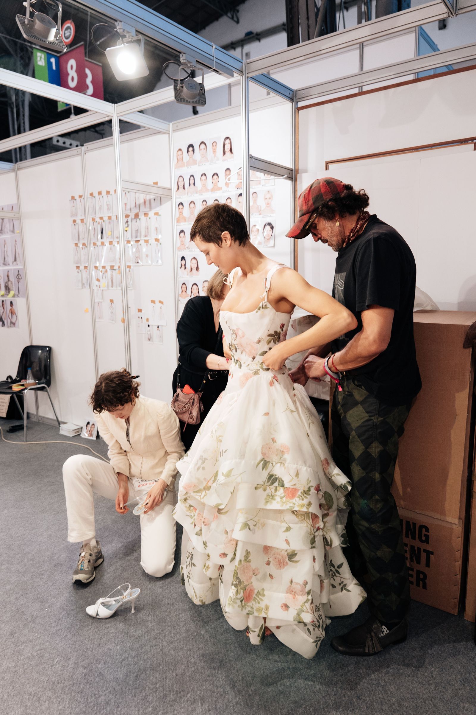 Image may contain Vicky Krieps Steve Balbi Clothing Dress Fashion Formal Wear Gown Wedding Wedding Gown and Chair